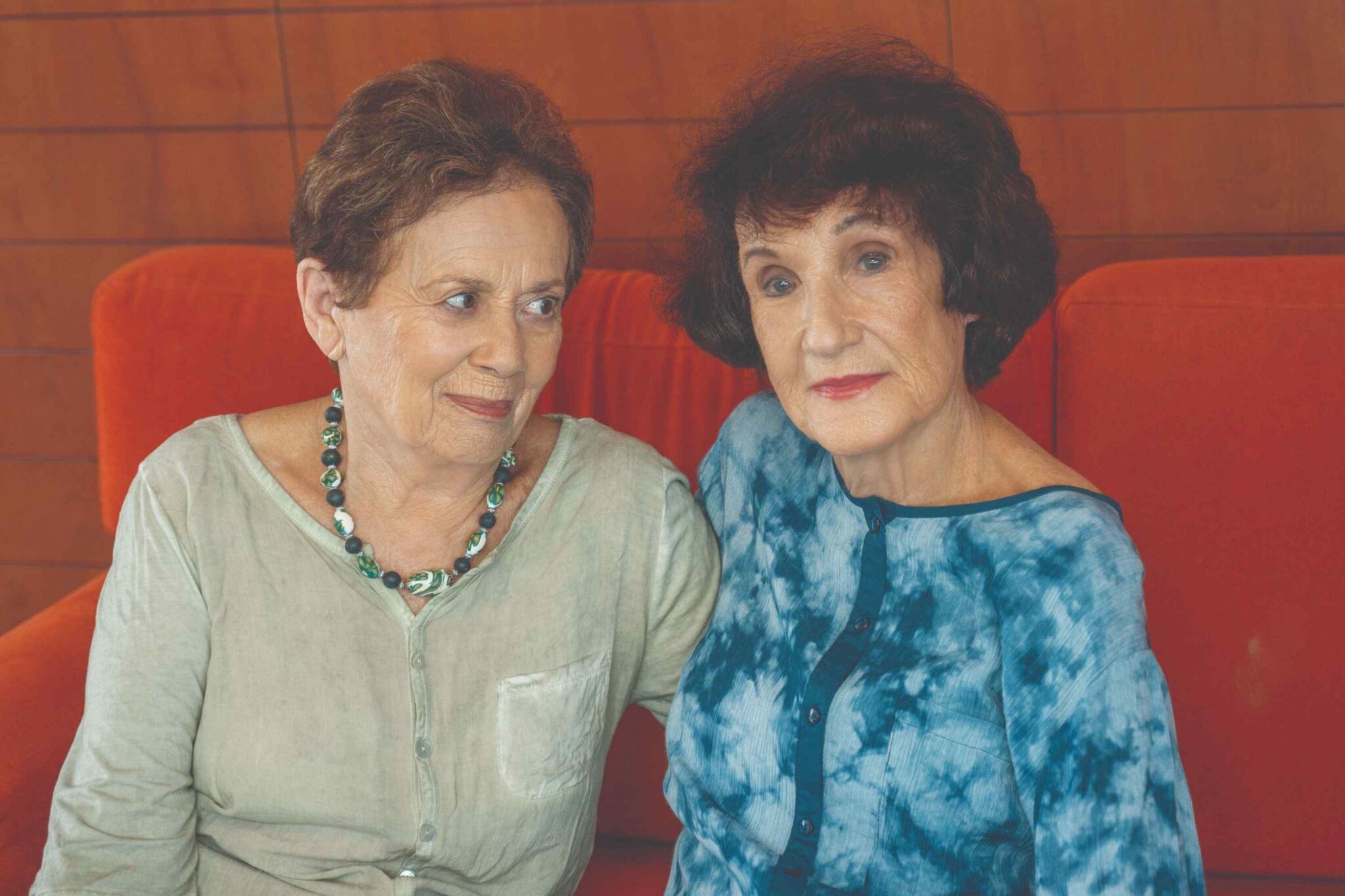 זוג חברות בגיל השלישי יושבות מחובקות
